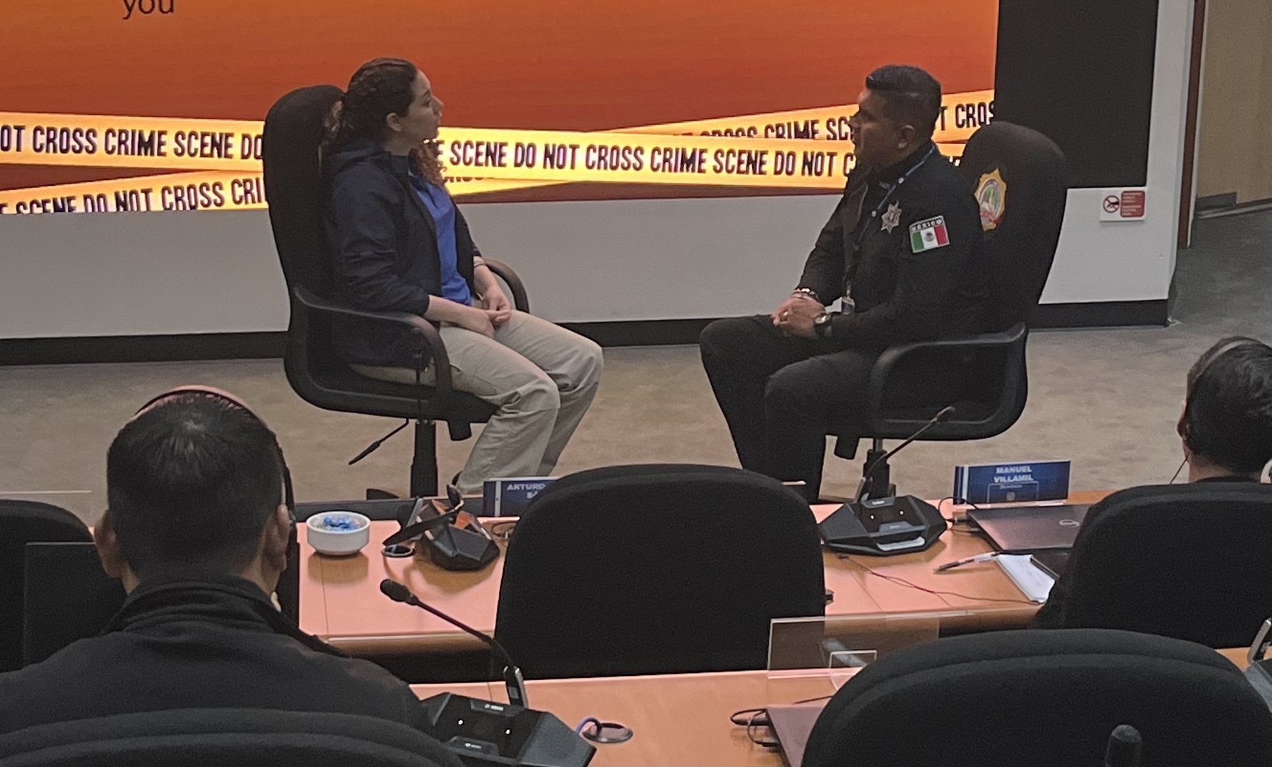Two people seated in a practical interview training exercise